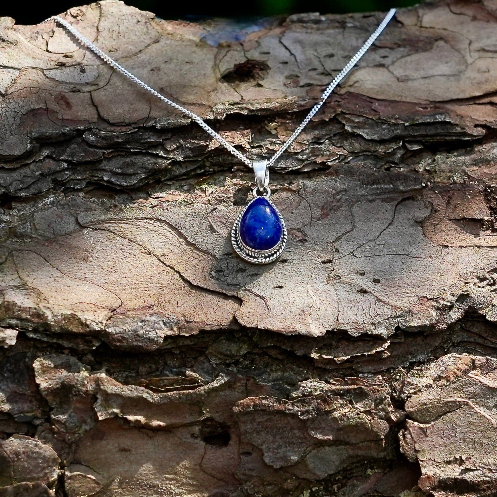 Halsketting met zilveren hanger Nubbu met Lapis lazuli en zilveren omlijsting op boomschors - Juwelen uit de Natuur